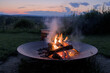 © Yuriy T - round circle fire pit burning logs at sunset in catskills mountains catskill upstate new york travel camping leisure scenic nature landscape flame wood wooden log warmth cozy outdoor adventure