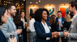 © bazou - Business professionals networking and shaking hands at a social event, discussing ideas and making connections