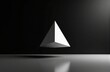 © starush - A minimalist black and white image featuring a geometric pyramid floating above a reflective surface