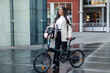 © EDER - Latin businesswoman commuting with electric folding bike in city
