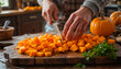 © Svetlana - Man cutting pumpkin for home cooking on wooden table, vegetarian food.