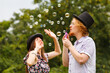 © Voyagerix - Couple blowing soap bubbles, having fun