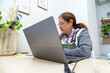 © pacoocimage - Woman concentrating working on laptop at home office