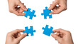 © jsmahmud - Four hands holding blue puzzle pieces isolated on transparent background