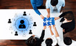 © InfiniteFlow - Diverse group of professionals collaborating on puzzle pieces, symbolizing teamwork and strategy. Engaged in planning session to drive business solutions forward. Trope