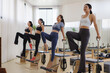 © Phimwilai - Young women doing pilates chair exercise in studio
