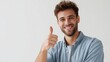 © fotofabrika - Smiling young man giving a thumbs up in a bright indoor setting