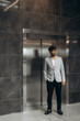 © Roman - Professional Man Standing Beside Elevator in Modern Business Environment