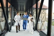 © LIGHTFIELD STUDIOS - Multicultural doctors collaborating in a modern hospital setting
