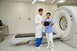 © LIGHTFIELD STUDIOS - Diverse team of doctors collaborating on MRI results in a modern hospital environment
