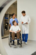 © LIGHTFIELD STUDIOS - Healthcare team preparing a patient for an MRI scan in a modern hospital setting