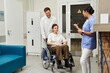 © LIGHTFIELD STUDIOS - Healthcare professionals support patient in modern hospital for MRI scan preparation