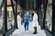 © LIGHTFIELD STUDIOS - Diverse medical professionals collaborate in a modern hospital setting