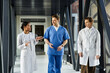 © LIGHTFIELD STUDIOS - Three multicultural doctors collaborating in a modern hospital environment