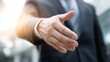 © Phakorn - Businessman Extending Hand for Handshake, Professional Greeting and Partnership Concept