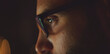 © Videophilia - Man with stylish glasses lit by a blue screen glow, intently focusing on data in a dark home office — representing technology, concentration, late-night work and digital engagement
