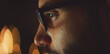 © Videophilia - Man wearing glasses with a screen light reflection, concentrating on work in a dark environment during the night, representing technology, focus, and digital lifestyle