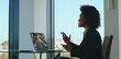 © Videophilia - Professional black woman having an important video call discussion on a laptop with a colleague, communicating and collaborating during a remote work meeting in a modern office