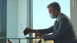 © Videophilia - Businessman wearing a protective face mask while working diligently on his laptop at a modern office desk, adapting to new normal workplace safety protocols during the global pandemic