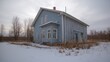 © AkuAku - Deserted village houses covered in snow under a cold winter sky