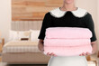 © New Africa - Chambermaid with clean towels in hotel room, closeup