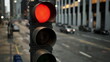 © icetray - A vibrant red traffic light stands tall amidst a bustling cityscape at dusk. Vehicles are lined up, waiting patiently as the golden glow of streetlights starts to illuminate the urban scene.
