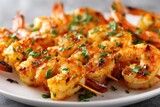 Deliciously seasoned and grilled crustaceans presented on wooden skewers cover a white serving dish.