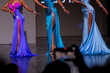 © Андрей Рыков - Contestants display stunning gowns in vibrant colors during a beauty pageant. The event takes place in the evening, capturing the grace and style of the participants.