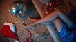 © Alchemy - Glamorous woman in blue dress resting after festive New Year celebration, sparkling disco ball, confetti, golden high heels and Santa hat on floor, luxury holiday party night atmosphere