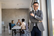© NDABCREATIVITY - Multicultural professional businesspeople working together on research plan in boardroom.