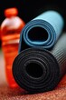 © Konstiantyn Zapylaie - Blue and black yoga mats with orange bottle on floor