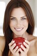 © Konstiantyn Zapylaie - Smiling caucasian woman holding red apple close-up