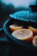 © Konstiantyn Zapylaie - Freshly sliced lemons in a steaming black cooking pot with lids and water droplets