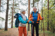 © Юлия Завалишина - Hiking tourism adventure. Senior couple man woman enjoying outdoor recreation hiking in forest. Happy old people backpackers hikers enjoy walking hike trekking tourism active vacation beauty of nature