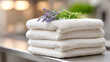 © sabyna75 - Industrial laundry room close-up of folded white towels with lavender for spa decor