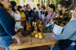 © Marcos - Group of Latin American Adult Students With Teacher Preparing recipe ingredients in Cookery Class in Mexico. Hispanic people multi generations learning together to cook in a terrace outdoors