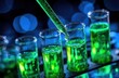 © Key - Green liquid drips into test tubes, blue bokeh backdrop