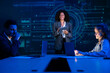 © VStudio - Diverse business team in a meeting, with a female leader presenting a global strategy on a large screen.