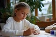 © Iryna - Young caucasian girl engaged in creative artwork at home