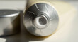 © Platon - Close-up of open aluminum cream tube with fresh product inside.A close-up, high-key studio shot focuses on the open nozzle of an aluminum cosmetic or pharmaceutical tube