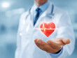 © CaptureCollabStudios - Doctor holding a digital heart symbol with cardiac rhythm at a m