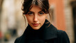 © alexandre - Captivating portrait of a stylish young woman with an intense gaze in an urban setting