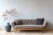 © Basileus - Minimalist sofa with dried branches in a vase against a textured wall.
