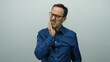 © Krakenimages.com - Hispanic man experiencing tooth pain against a white background, clutching his jaw with a pained expression, isolated in a senior mature context showing dental discomfort.