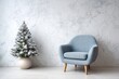 © Basileus - Light blue armchair with a small frosted Christmas tree stands against a marble wall.