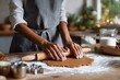 © Галя Дорожинська - Baker rolling out raw gingerbread dough on a wooden kitchen table