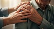 © ivatekstudio - Image of Comfort: A compassionate younger hand offers solace, tenderly touching the shoulder of an elderly person, their hands conveying empathy and support in a moment of shared human connection.