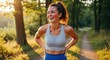© Fabio - Happy athletic woman laughing after running workout in a sunny forest. Sweaty fit female taking a break. Concept of healthy lifestyle, sport motivation, wellness and body positive.