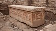 © 69 - Ancient stone sarcophagus with intricate carvings discovered in archaeological excavation site surrounded by earth and rubble