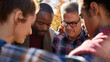 © olgakris - Diverse group of people standing in a circle and praying outdoors during a sunny autumn day, heads bowed, eyes closed, expressing unity, spirituality, and support through a moment of faith